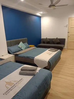 a room with three beds and a couch at Fahrenheit 88 4R in Kuala Lumpur