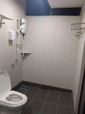 a bathroom with a toilet and a phone on the wall at Fahrenheit 88 4R in Kuala Lumpur