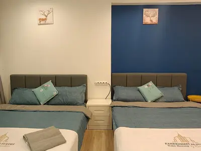 two beds in a room with blue walls at Fahrenheit 88 4R in Kuala Lumpur