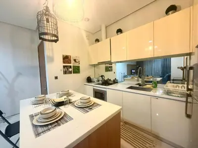 a kitchen with a counter with plates on it at Soho Suites KLCC by MIMI in Kuala Lumpur