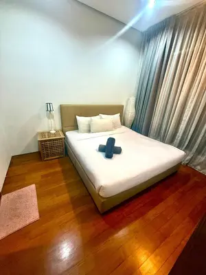 a bedroom with a bed with a blue pillow on it at Soho Suites Klcc By Bukit Bintang in Kuala Lumpur