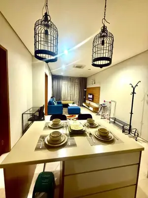 a kitchen with a island with plates and birds cages at Soho Suites Klcc By Bukit Bintang in Kuala Lumpur