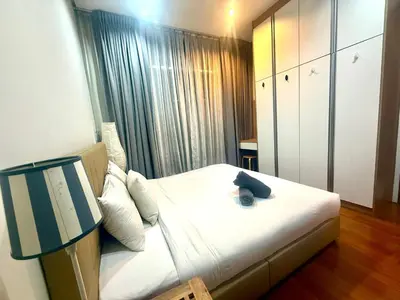 a hotel room with a bed with a lamp on it at Soho Suites Klcc By Bukit Bintang in Kuala Lumpur