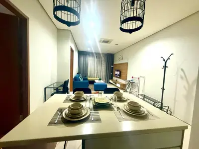 a kitchen with a table with dishes on it at Soho Suites Klcc By Bukit Bintang in Kuala Lumpur