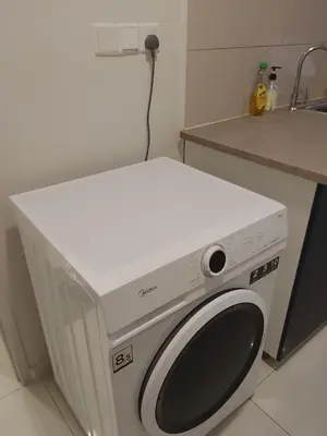 a washing machine in a kitchen next to a counter at Majestic Suites Quill Mall Apartment in Kuala Lumpur