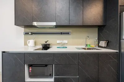 a kitchen with a sink and a microwave at The Atrium by The Conts in Kuala Lumpur