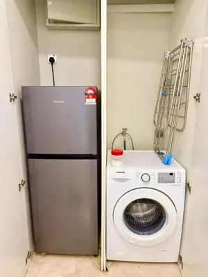 a washing machine and a washer in a room at vortex suites apatment by sapporo in Kuala Lumpur