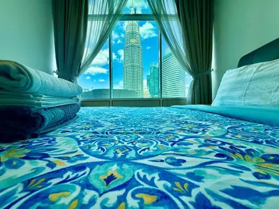 a bedroom with a bed with a view of a city at vortex suites klcc by park view in Kuala Lumpur