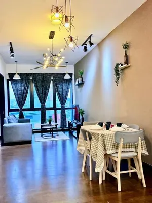 a living room with a table and a couch at Lux Homestay At Sunway Velocity Kuala Lumpur in Kuala Lumpur