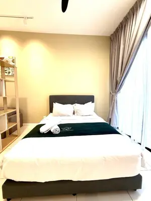 a bedroom with a large bed with a window at Chambers Suites By Grands in Kuala Lumpur
