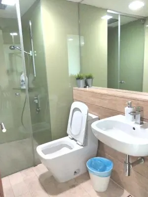 a bathroom with a toilet and a sink and a shower at Vortex suites Klcc near KL in Kuala Lumpur