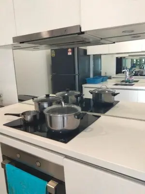 a kitchen with four pots on a stove top at Vortex suites Klcc near KL Area in Kuala Lumpur