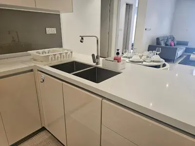 a kitchen with a sink and a living room at Spacious Stylish Suite at Quill Resi KLCC 2Bed7Pax in Kuala Lumpur