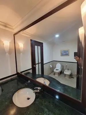 a bathroom with a sink and a toilet and a mirror at Suite at Bukit Bintang in Kuala Lumpur