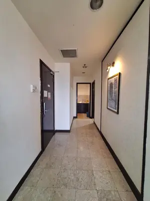 a hallway with white walls and a tile floor at Suite at Bukit Bintang in Kuala Lumpur