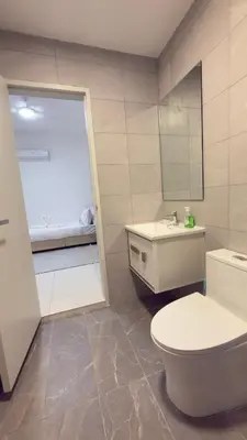 a bathroom with a white toilet and a sink at Majestic Sky Deck Suites in Kuala Lumpur