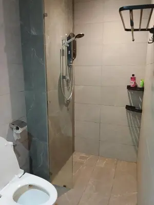 a shower stall with a toilet in a bathroom at Quill Luxury Suites KLCC in Kuala Lumpur