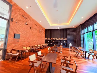 a restaurant with tables and chairs and a brick wall at Chambers Suites KLCC in Kuala Lumpur