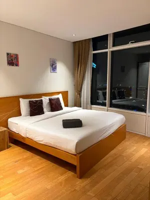 a bedroom with a large bed with a large window at SKY SUITES DMK KHADIZA GLOBAL BY KLcc in Kuala Lumpur