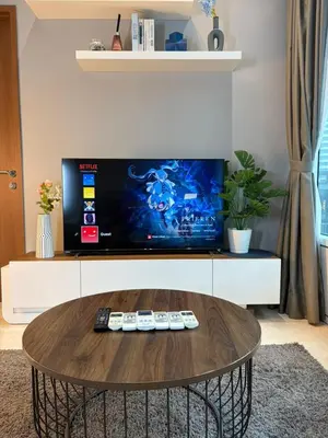 a coffee table in a living room with a tv at SKY SUITES DMK KHADIZA GLOBAL BY KLcc in Kuala Lumpur