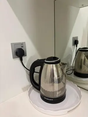 a black and silver tea kettle sitting on a counter at SKY SUITES DMK KHADIZA GLOBAL BY KLcc in Kuala Lumpur