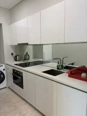 a white kitchen with white cabinets and a sink at SKY SUITES DMK KHADIZA GLOBAL BY KLcc in Kuala Lumpur