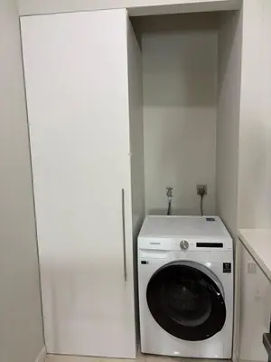 a washer and dryer in a room with a wall at SKY SUITES DMK KHADIZA GLOBAL BY KLcc in Kuala Lumpur