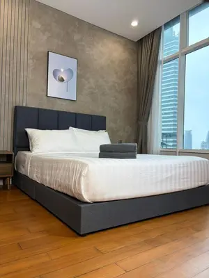 a large bed in a bedroom with a large window at SKY SUITES DMK KHADIZA GLOBAL BY KLcc in Kuala Lumpur