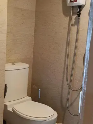 a bathroom with a toilet and a shower at Female Hostel Regalia Residence in Kuala Lumpur