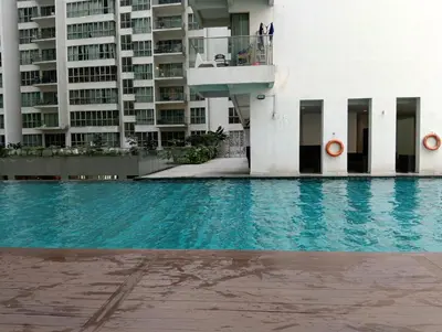 a swimming pool in front of a building at Female Hostel Regalia Residence in Kuala Lumpur