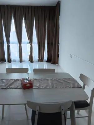 a table and chairs in a room with a large window at Female Hostel Regalia Residence in Kuala Lumpur