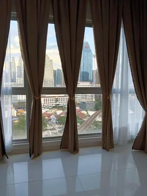 a large window with a view of a city at Female Hostel Regalia Residence in Kuala Lumpur