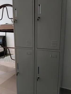 two white cabinets in a room with a bed at Female Hostel Regalia Residence in Kuala Lumpur