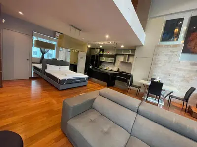 a living room with a couch and a bed at Kuala Lumpur luxury Duplex suits in Kuala Lumpur
