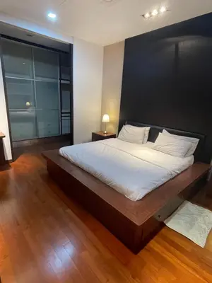 a bedroom with a large bed with a black wall at Kuala Lumpur luxury Duplex suits in Kuala Lumpur