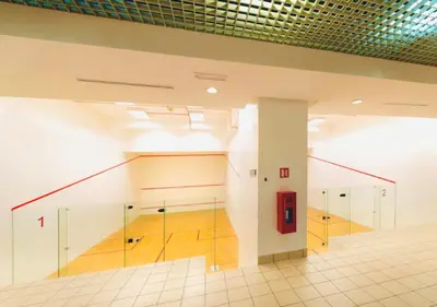 a tennis court with a staircase in a building at Times Square Service Apartment KL in Kuala Lumpur