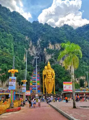 a large golden statue in front of a mountain at Times Square Service Apartment KL in Kuala Lumpur