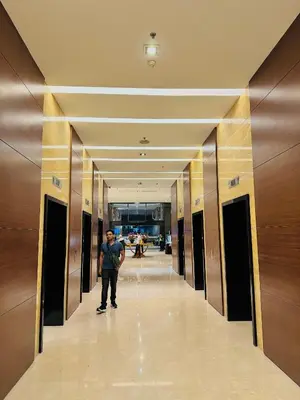 a man standing in a hallway in a building at Times Square Service Apartment KL in Kuala Lumpur