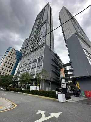 a tall building with an arrow on a street at Agile Family Suites -TRX Kualalampur in Kuala Lumpur