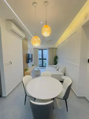 a living room with a white table and chairs at Agile Family Suites -TRX Kualalampur in Kuala Lumpur