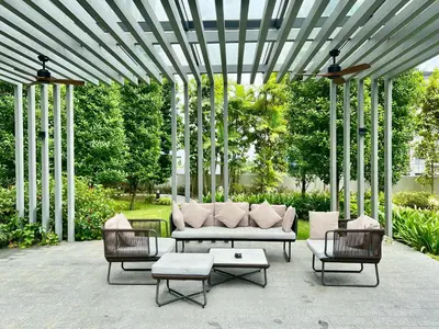 a patio with a couch and two chairs and a table at Agile Family Suites -TRX Kualalampur in Kuala Lumpur