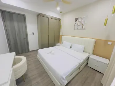 a bedroom with a white bed and a bathroom at Agile Family Suites -TRX Kualalampur in Kuala Lumpur