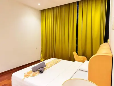 a room with two beds and a yellow curtain at Next To KLCC By Home Stay in Kuala Lumpur