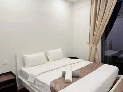 a bedroom with a large white bed with white pillows at Home Town Next To Kuala Lumpur City in Kuala Lumpur