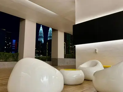 a room with two white chairs and a large window at Home Town Next To Kuala Lumpur City in Kuala Lumpur