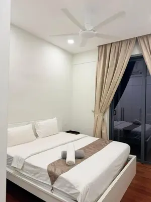 a white bedroom with a bed with a ceiling fan at Home Town Next To Kuala Lumpur City in Kuala Lumpur