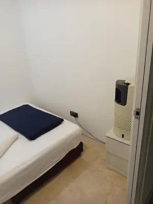 a bedroom with a bed and a small tv at Vortex Amira suites klcc Apartment in Kuala Lumpur