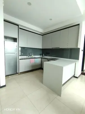 a kitchen with white cabinets and a refrigerator at Opus Residence KL118 By Millennium Suite in Kuala Lumpur
