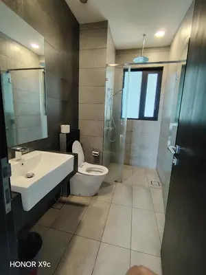 a bathroom with a toilet and a sink and a shower at Opus Residence KL118 By Millennium Suite in Kuala Lumpur