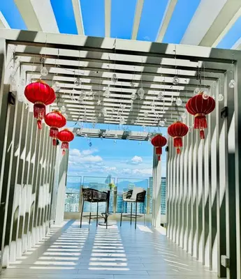 a balcony with red lanterns and a table and chairs at Agile Residence Kuala Lumpur Bukit Bintang in Kuala Lumpur